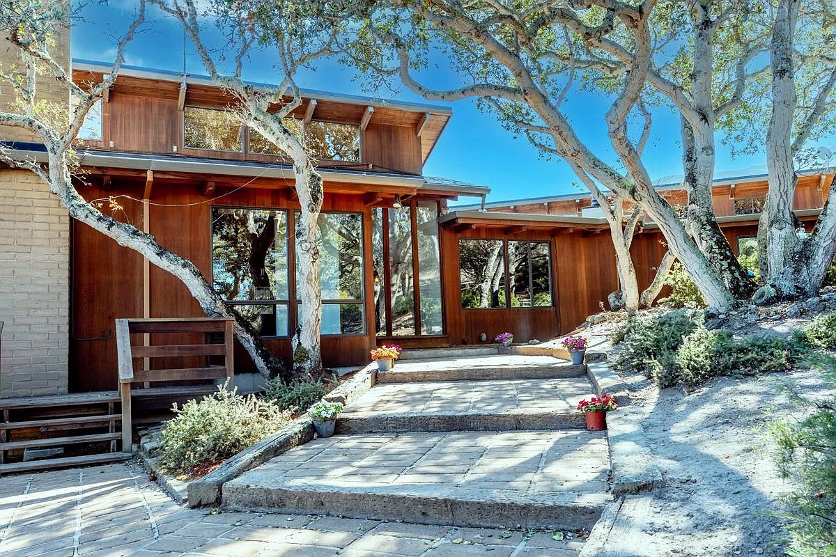 Stone steps and the front door of the house under the oaks