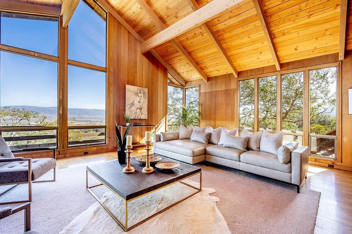 The living room sofa under the wood ceiling, oaks outside the windows