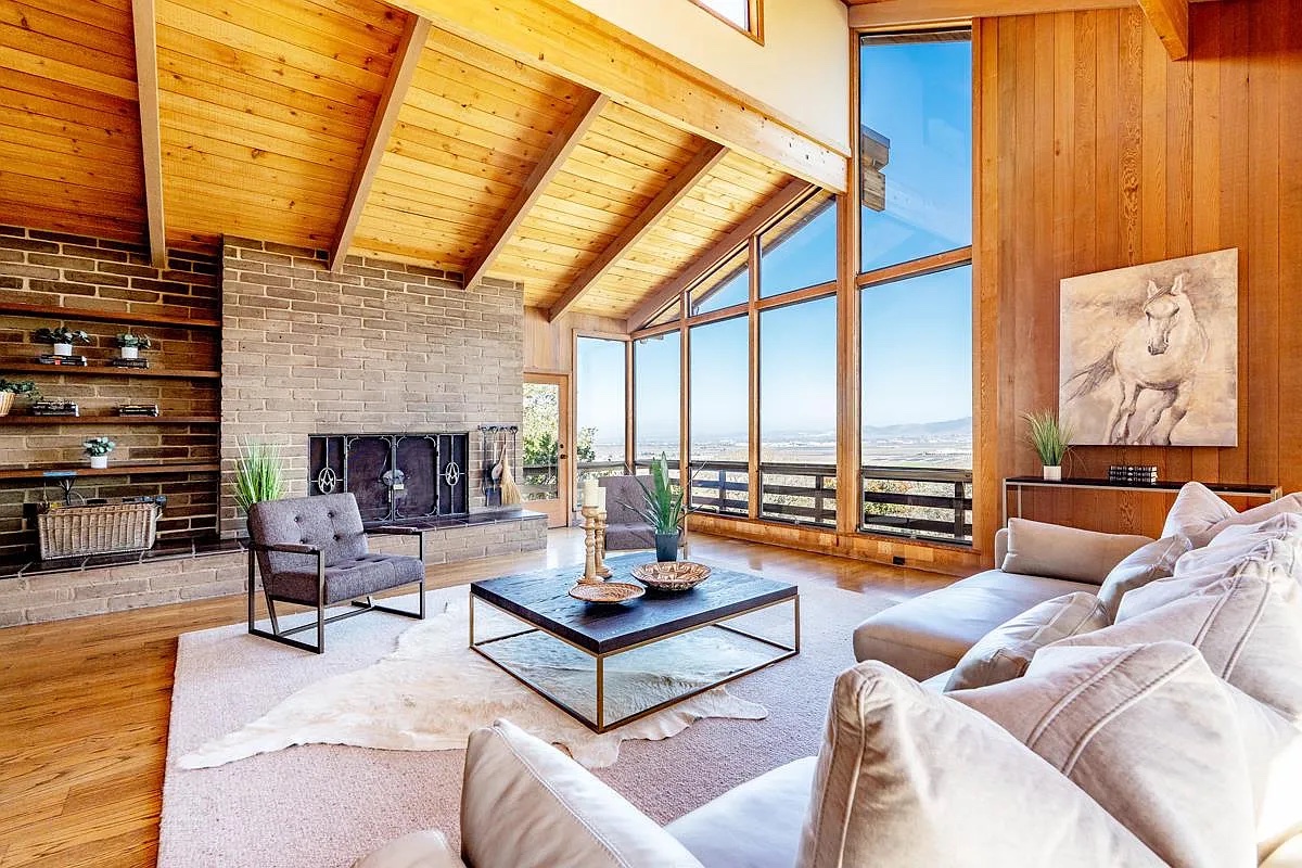 The living room, fireplace and valley windows
